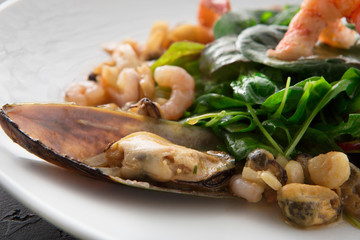 Warm salad with grilled seafood close up