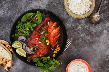 Tandoori chicken  with spicy pilau rice, peshwari naan  and raita. Top view, blank space - obrazy, fototapety, plakaty
