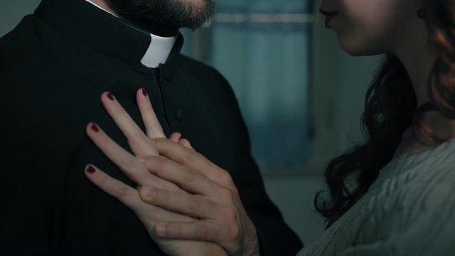 priest gives in to the advances of a sexy woman:sin, religion