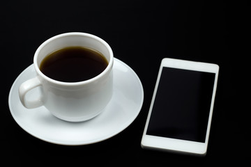 Fototapeta na wymiar top view coffe cup and smartphone ona a black table