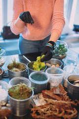 Master class on planting succulents in the florarium of glass The Floriana. Girls plant plants. Hands of the girl close-up. Making a gift and a piece of interior handmade. DIY present