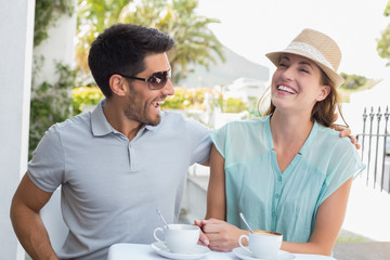 Cheerful young couple at coffee shop