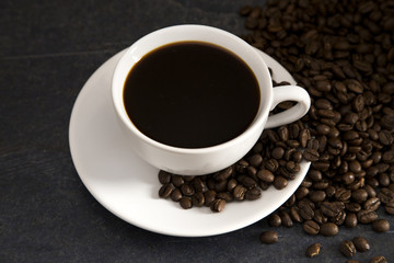 Fototapeta premium Cup of Strong Black Coffee in a White Cup and Saucer
