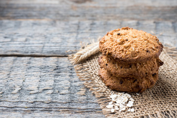 Oatmeal cereal cookies on napkin burlap wood table