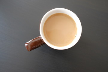 shot of cup of coffee on table against black background