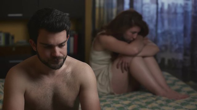  sexual problem:  Sad couple in bed
