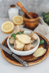 Ginger root and slices  in bowl