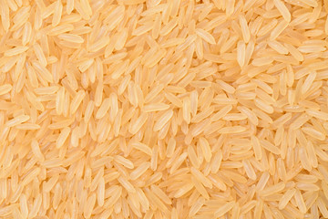 A beautiful and voluminous long rice, raw, not cooked. Surface of rice cerea. Yellow rice close-up