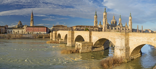 Fototapeta na wymiar Zaragoza - The panorama of bridge Puente de Piedra and Basilica del Pilar in the morning light.