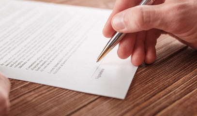 Close up business man signing contract making a deal