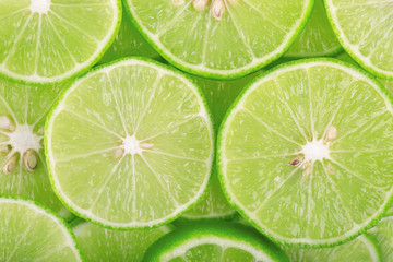 Green background with citrus fruit of lime slices.