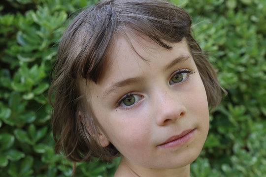 Portrait Of Green Eyes Girl Looking Over Shoulder 