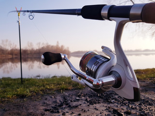 Fisherman's reel, mounted on a fishing rod.