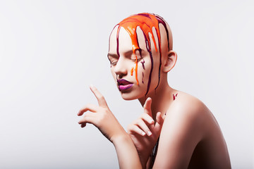 Studio shot of hairless woman with paint on head