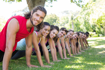 Fitness group planking in park