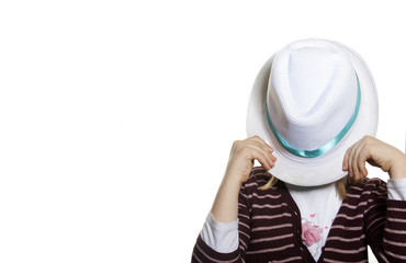 Funny kid covering her face with hat