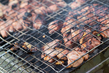 Cooking chicken grilled on the grill. Grill the fillets on the grill over the coals of the close-up