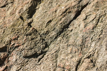 Natural stone granite texture, granite pattern. Stone background of mottled granite igneous rock used for kitchen worktops etc. Surface of the marble with brown tint. Minimalism
