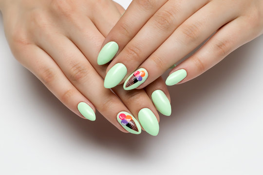 mint, light green manicure on sharp long nails with painted ice cream
