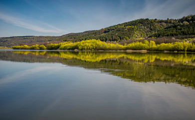 river landscape. Photo from the boat. A lot of sky. Blue sky with clouds. Greenish waves. Summer. the Dniester River