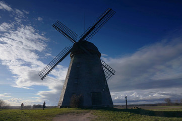 Fototapeta na wymiar Working windmill, it was built in Europe. Dark sky background.