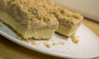 A slice of yummy coffee cake or crumb cake sitting on a table