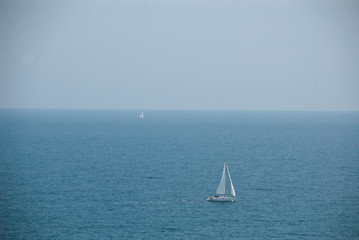 Two yachts with big sea space near Spain. Beautiful summer sea view.