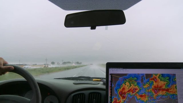 Inside a storm chaser's van on a rainy road
