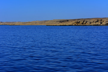Elevated above sea level, beautiful coral reefs the form mountains and rocks against the blue sky and clear sea water coast of the unique Ras Mohammed nature reserve. Magnificent diving, summer, rest.