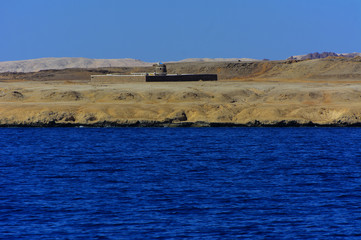 Elevated above sea level, beautiful coral reefs the form mountains and rocks against the blue sky and clear sea water coast of the unique Ras Mohammed nature reserve. Magnificent diving, summer, rest.