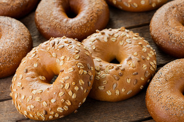 heap of fresh baked bagels on wooden background