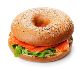 single bagel sandwich with salmon, cream cheese and arugula isolated on white background