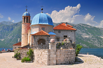 Our Lady of the Rock island and Church in Perast on shore of Boka Kotor bay (Boka Kotorska) Montenegro Europe.