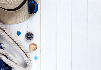 summer travel vacation concept flat lay, space for text. passport plane hat phone with empty screen and sunglasses and shells on white wooden background. hello summer.