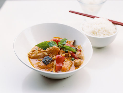 Close-up of a bowl of Asian food on white background