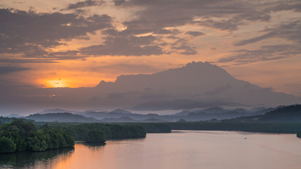 Fototapeta na wymiar Vew of Mengkabong river and Mt Kinabalu from Mengkabong bridge.