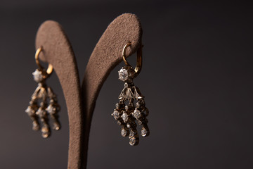 Diamond earrings jewellery, close-up. Beautiful luxury brilliant jewelry