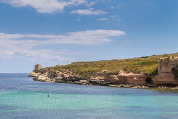 Naklejka premium Beautiful azure turquoise Mediterranean sea and white chalk limestone cliffs of St Thomas Bay, walking, trekking, hiking along the Munxar Path, Marsaskala, Malta