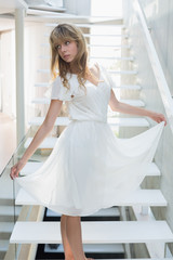 Young woman standing on stairs