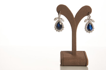 Diamond earrings with sapphires. Beautiful luxury jewelry, close-up