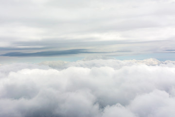 Fototapeta na wymiar Clouds through an airplane window