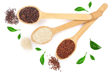 Black red white quinoa seeds in wooden spoon decorated with green leaves isolated on white background. Top view