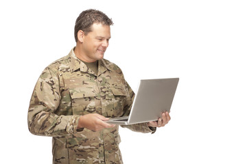 U.S. Army Soldier, Sergeant. Isolated with computer laptop.