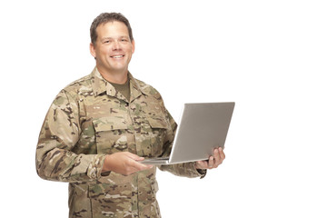 U.S. Army Soldier, Sergeant. Isolated while holding laptop.