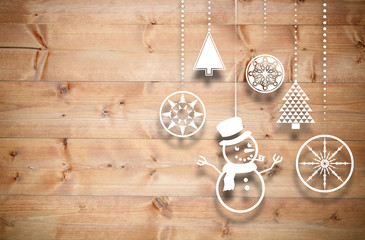 Hanging christmas decorations against bleached wooden planks background