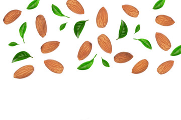 almonds decorated with leaves isolated on white background with copy space for your text. Top view. Flat lay pattern