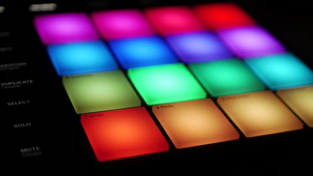 Music pattern playing from a digital audio workstation unit with large drum pads in studio