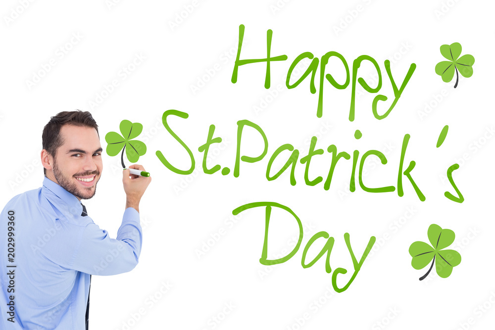 Canvas Prints Happy businessman in shirt writing with marker against shamrock