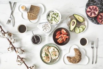 Enjoy healthy breakfast. Top view of different vegetarian food on the white marble table background.