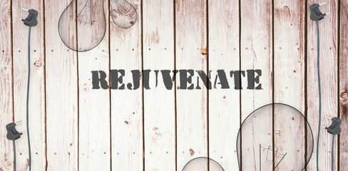 The word rejuvenate  against wooden background with plugs